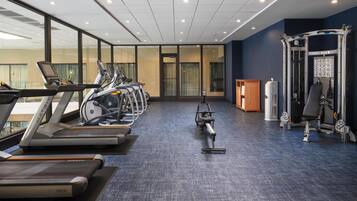 A gym with treadmills, a stationary bike, and a weight machine.