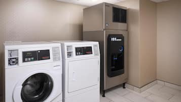 A laundry area with two washing machines and an ice dispenser.