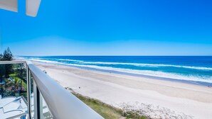 A beach view from a balcony with a clear sky. - Viscount on the Beach (Surfers Paradise)