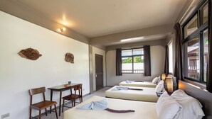 A hotel room with two beds, a desk, chairs, and a window with curtains. - DW Motel Palau (Koror)