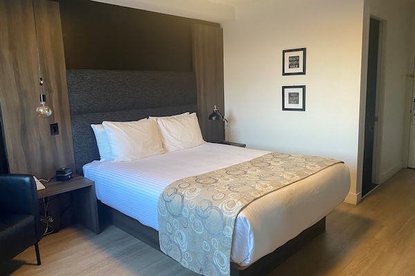 Desk, laptop workspace, blackout drapes, iron/ironing board