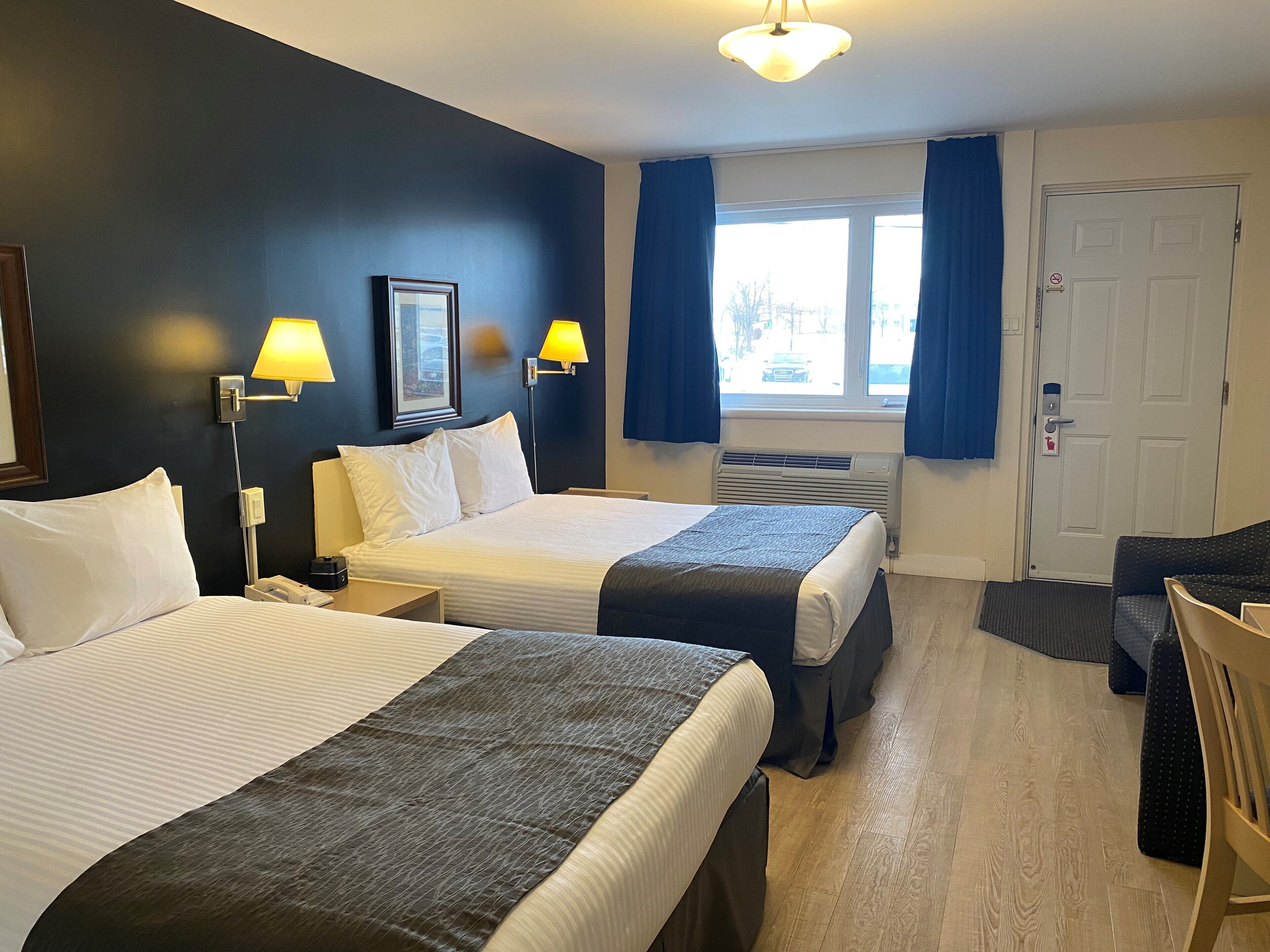 economy room, 2 double beds exterior entrance | desk, laptop workspace, blackout curtains, iron/ironing board