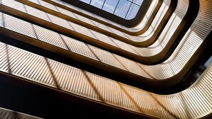 A spiral staircase with a modern design and a view of the sky through a glass panel. - Dorsett Shepherds Bush (London)
