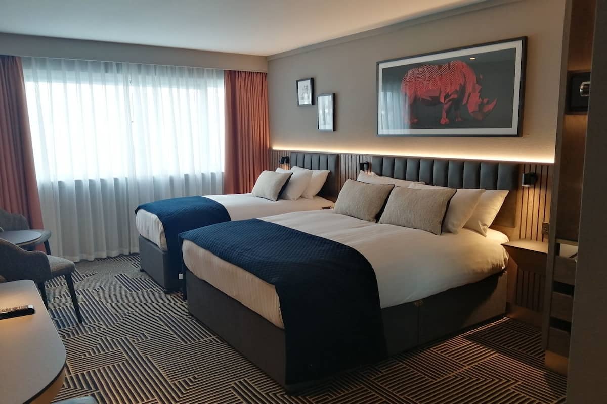 Premium bedding, desk, laptop workspace, blackout curtains