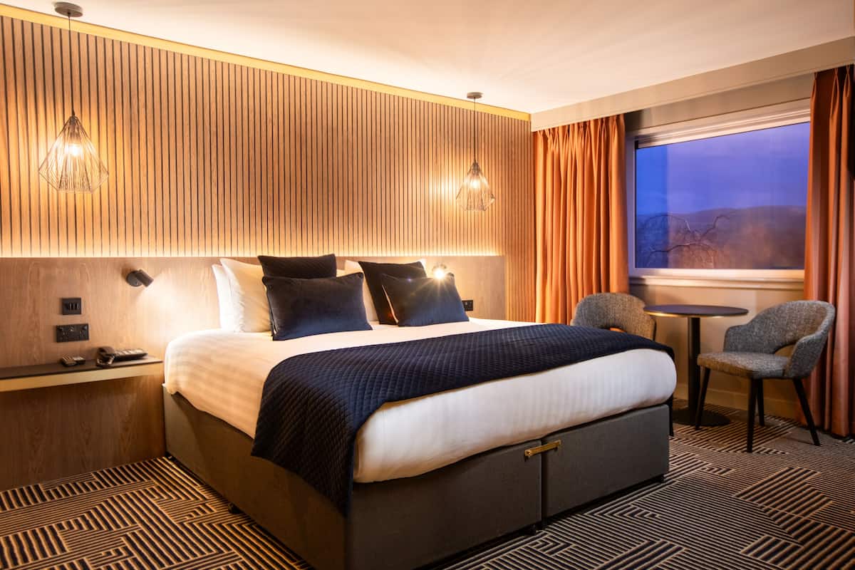 premium bedding, desk, laptop workspace, blackout curtains