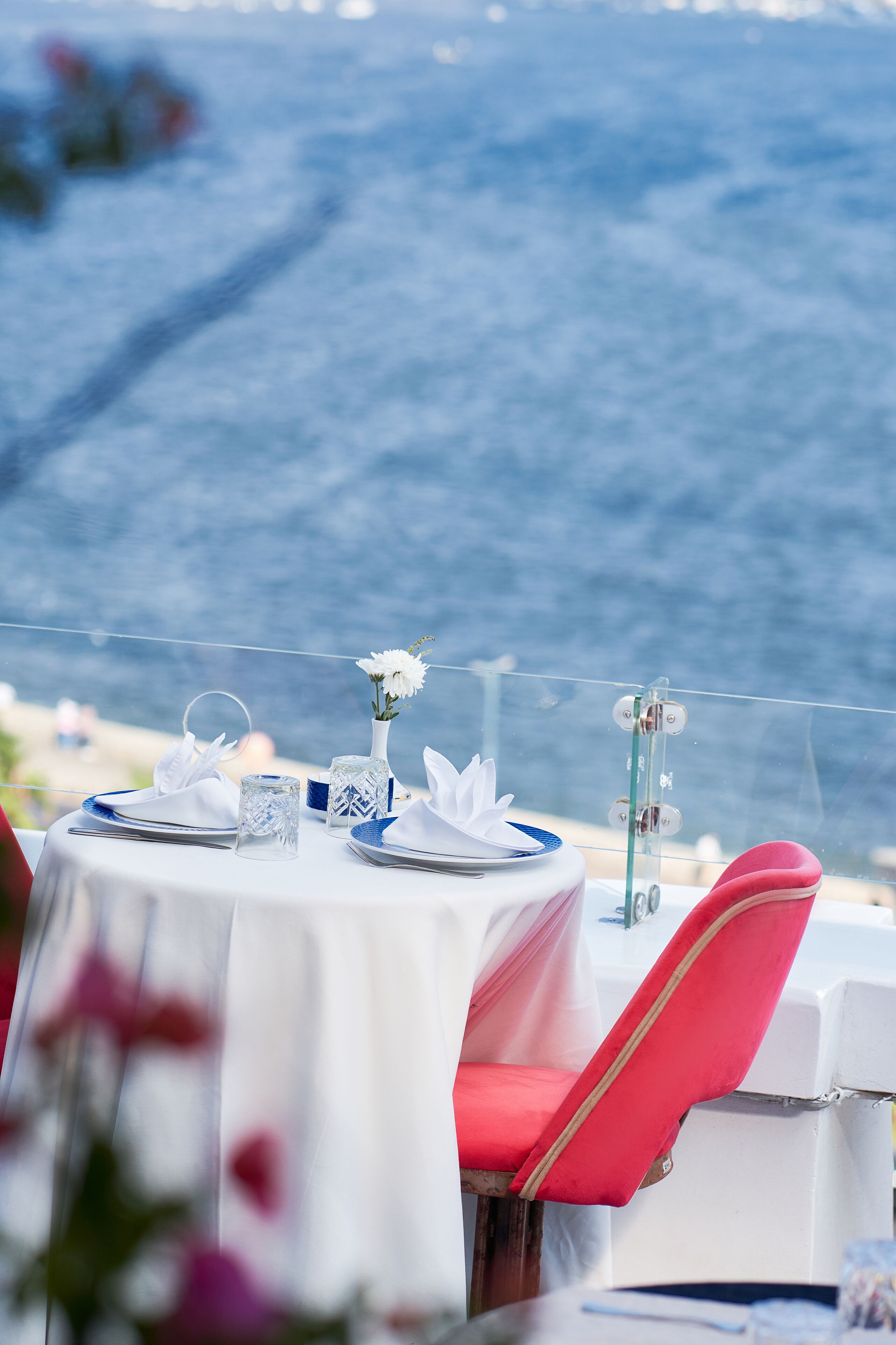A table set for two with a view of the sea.