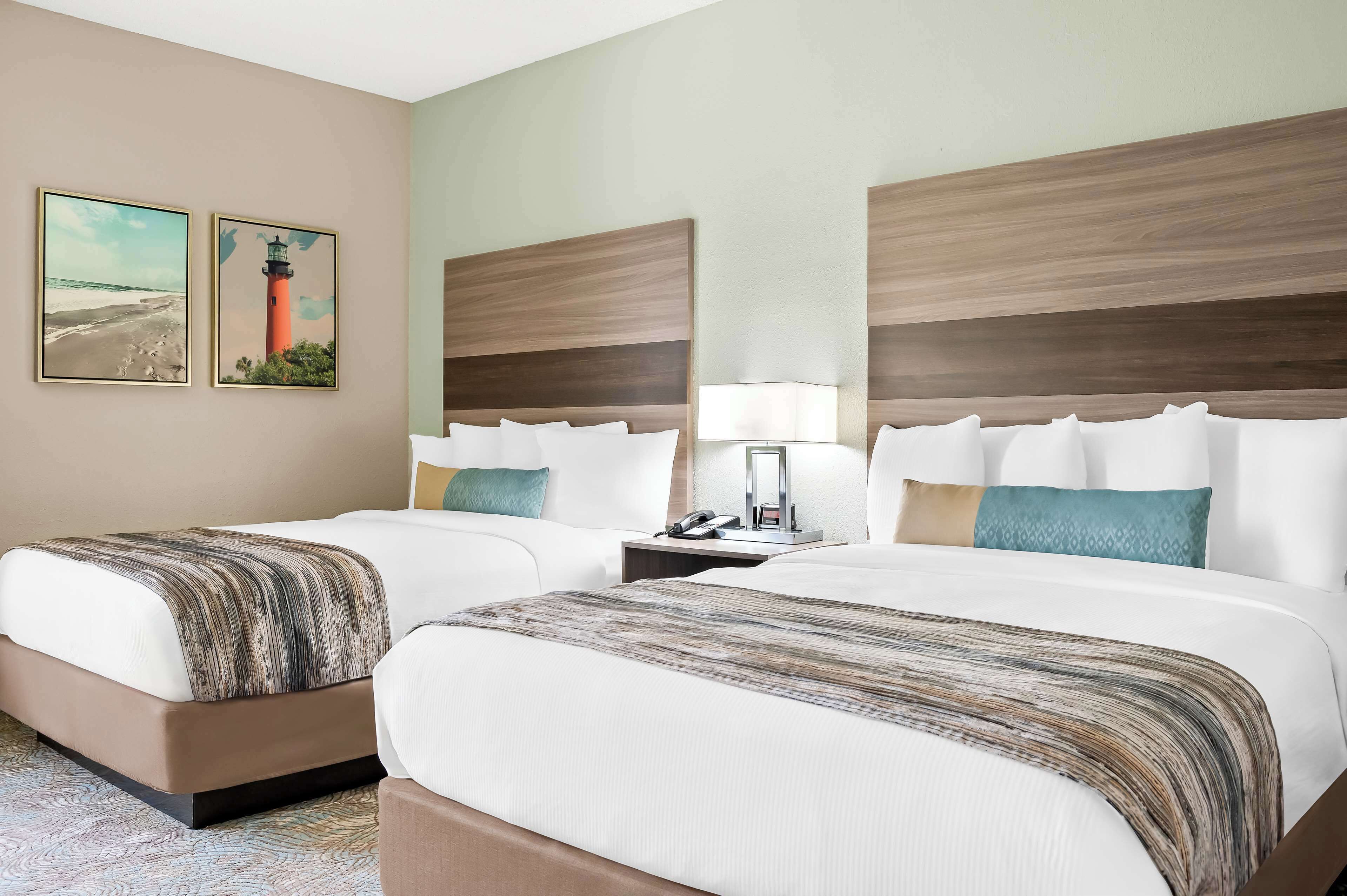 standard room, 2 queen beds, non smoking, refrigerator | pillow-top beds, desk, laptop workspace, blackout curtains