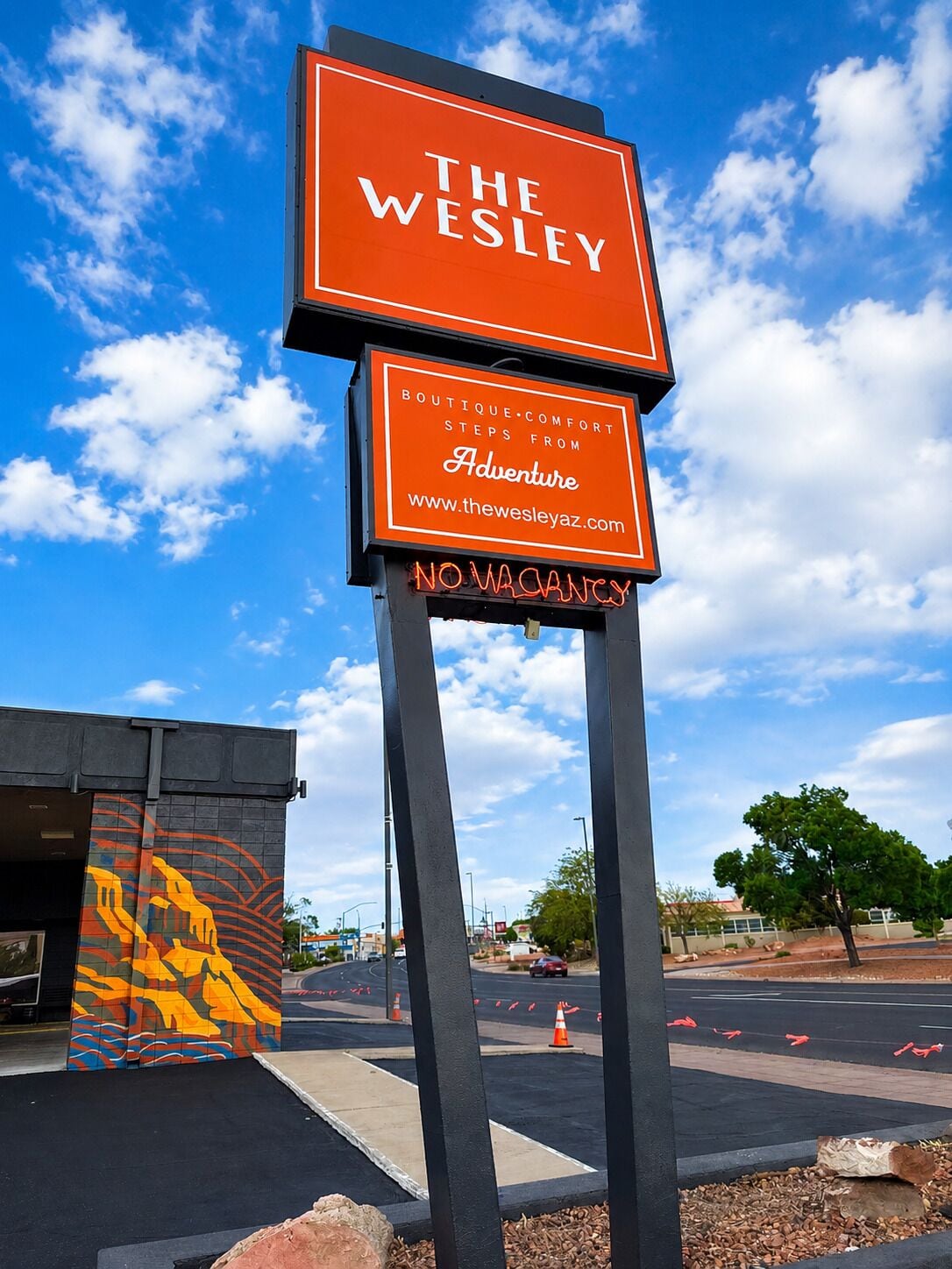A sign for 'The Wesley Boutique-Comfort Steps from Adventure' with a 'No Vacancy' notice.