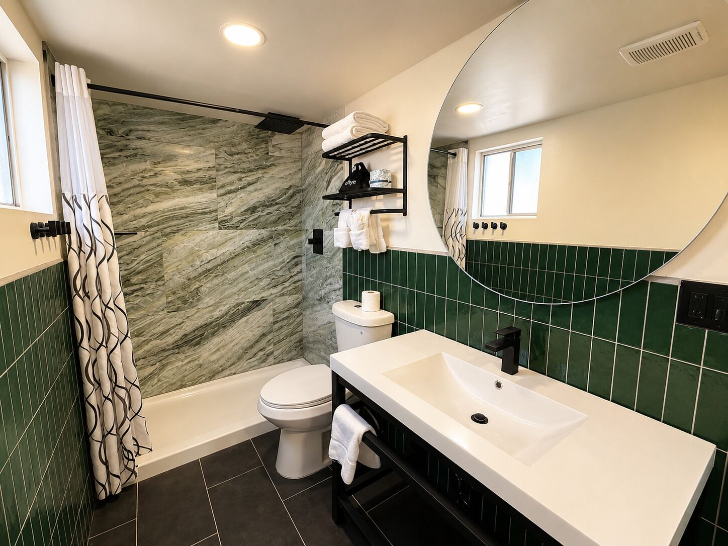 A bathroom with a bathtub, toilet, and sink.