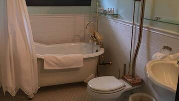 A bathroom with a bathtub, toilet, and sink.