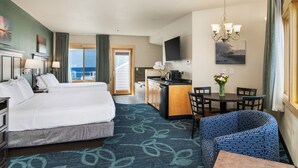 A hotel room with two beds, a kitchenette, a dining area, and a view of the sea. - Park Point Marina Inn (Duluth)