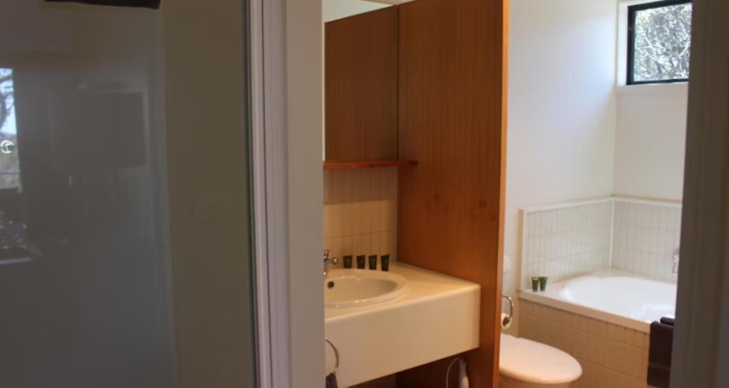 A bathroom with a sink, toilet, and bathtub.