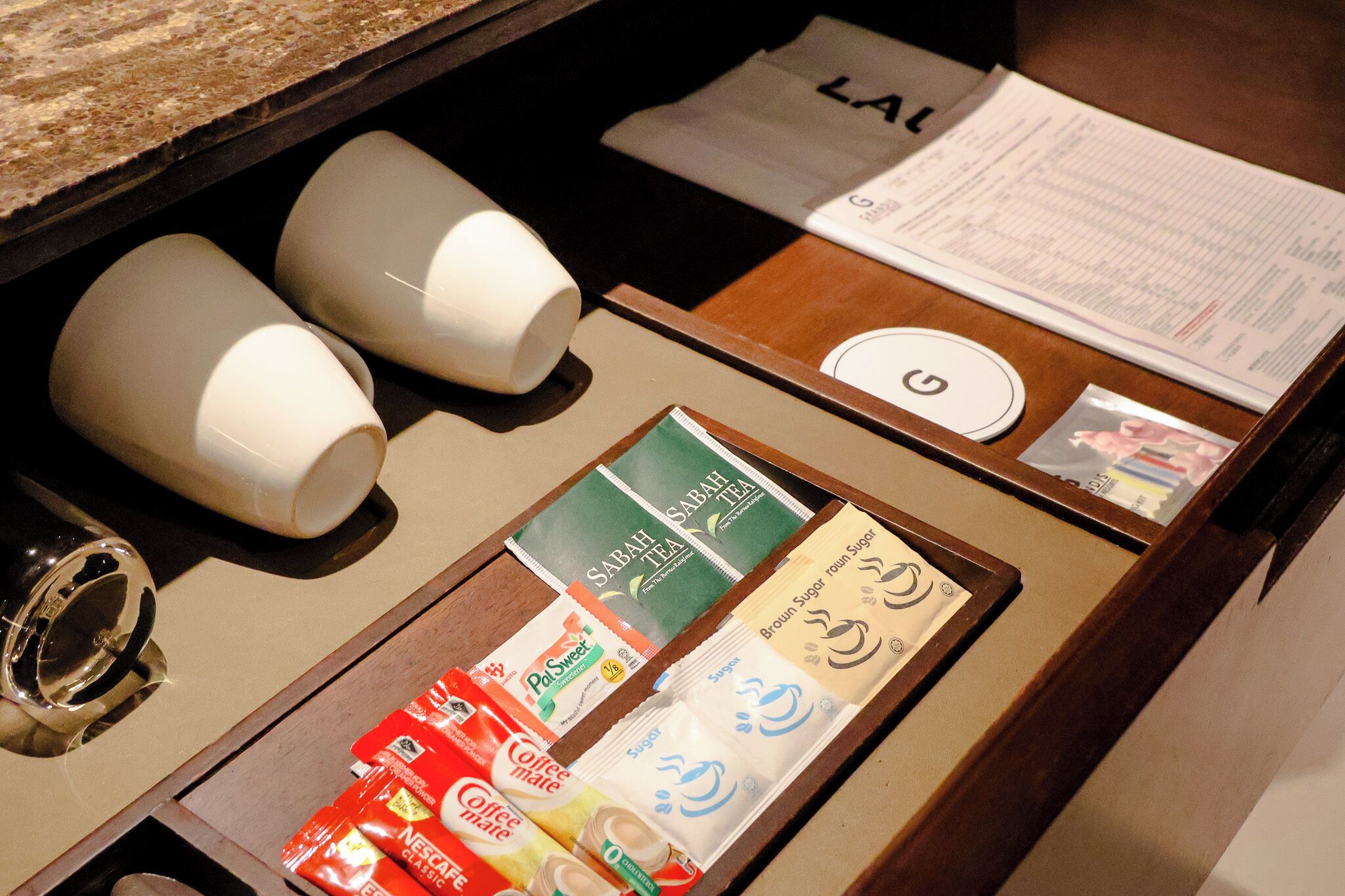 A coffee station with various coffee pods and a menu.