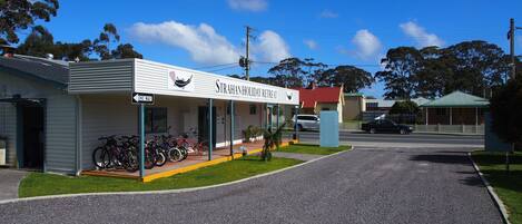 A building labeled "STRAHAN HOLIDAY RETREAT" with a one-way sign, a covered porch, and bicycles parked outside.