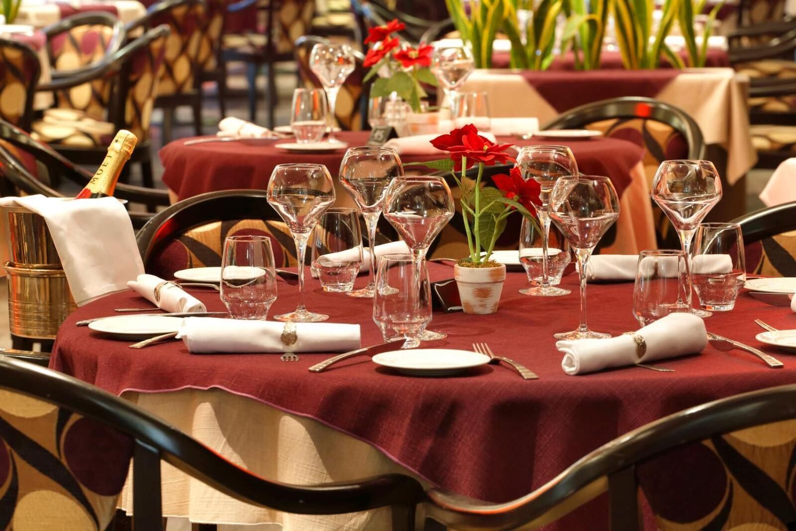A table set for dining with wine glasses, plates, and cutlery.