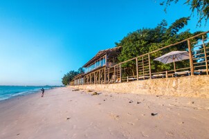 On the beach, white sand, beach towels, beach massages