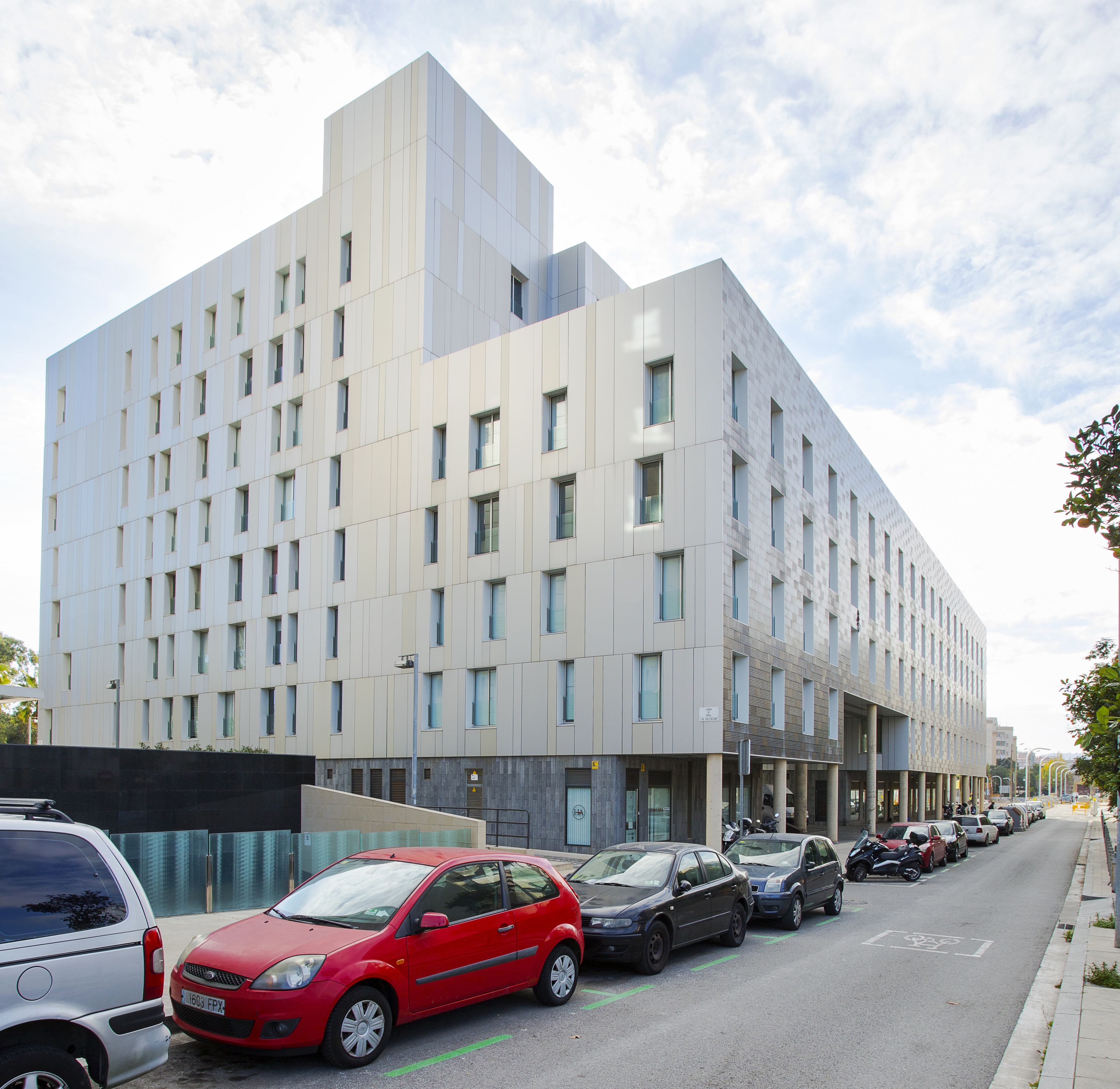 A modern building with a grid of windows and a flat facade.