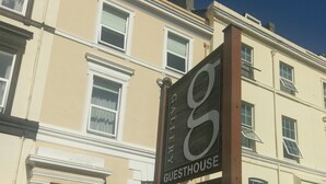 Un edificio con un cartel que dice "8 GUESTHOUSE".