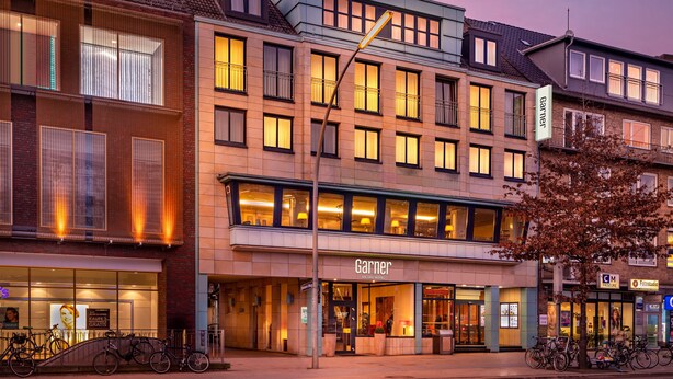 A hotel with a modern facade, multiple windows, and a visible entrance. - Garner Hotel Hamburg Wandsbek Marktplatz by IHG (Hamburg)