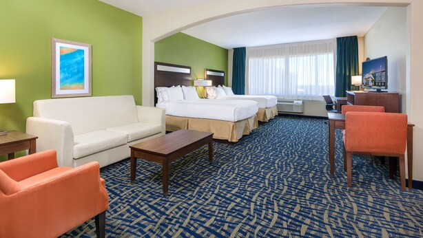 A hotel room with a bed, a sofa, a desk, and a chair. - Holiday Inn Express Hotel & Suites Monahans - I-20 by IHG (Monahans)