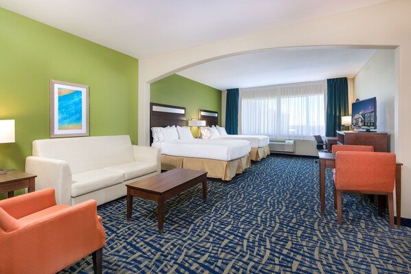 A hotel room with a bed, a sofa, a desk, and a chair. - Holiday Inn Express Hotel & Suites Monahans - I-20 by IHG (Monahans)