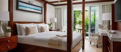 A four-poster bed with a ceiling fan, a television, and a view of the outdoors.