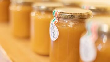 A close-up of several jars of honey with labels.