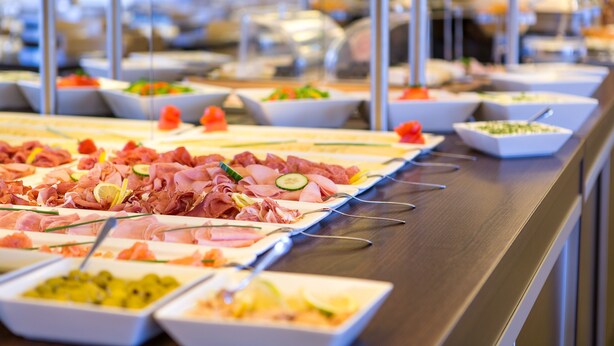 A buffet with various food options including meats, cheeses, and vegetables. - Zi Hotel & Lounge (Karlsruhe)