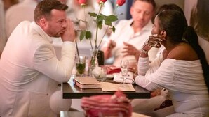 A dining table with a vase of roses, a notebook, and a glass of water. - Zi Hotel & Lounge (Karlsruhe)