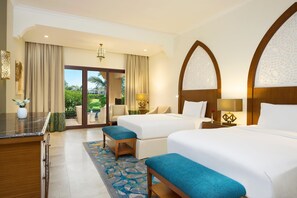 A hotel room with two beds, a desk, a chair, a small table, and a view of the outdoors. - DoubleTree by Hilton Resort & Spa Marjan Island (Ras Al Khaimah)
