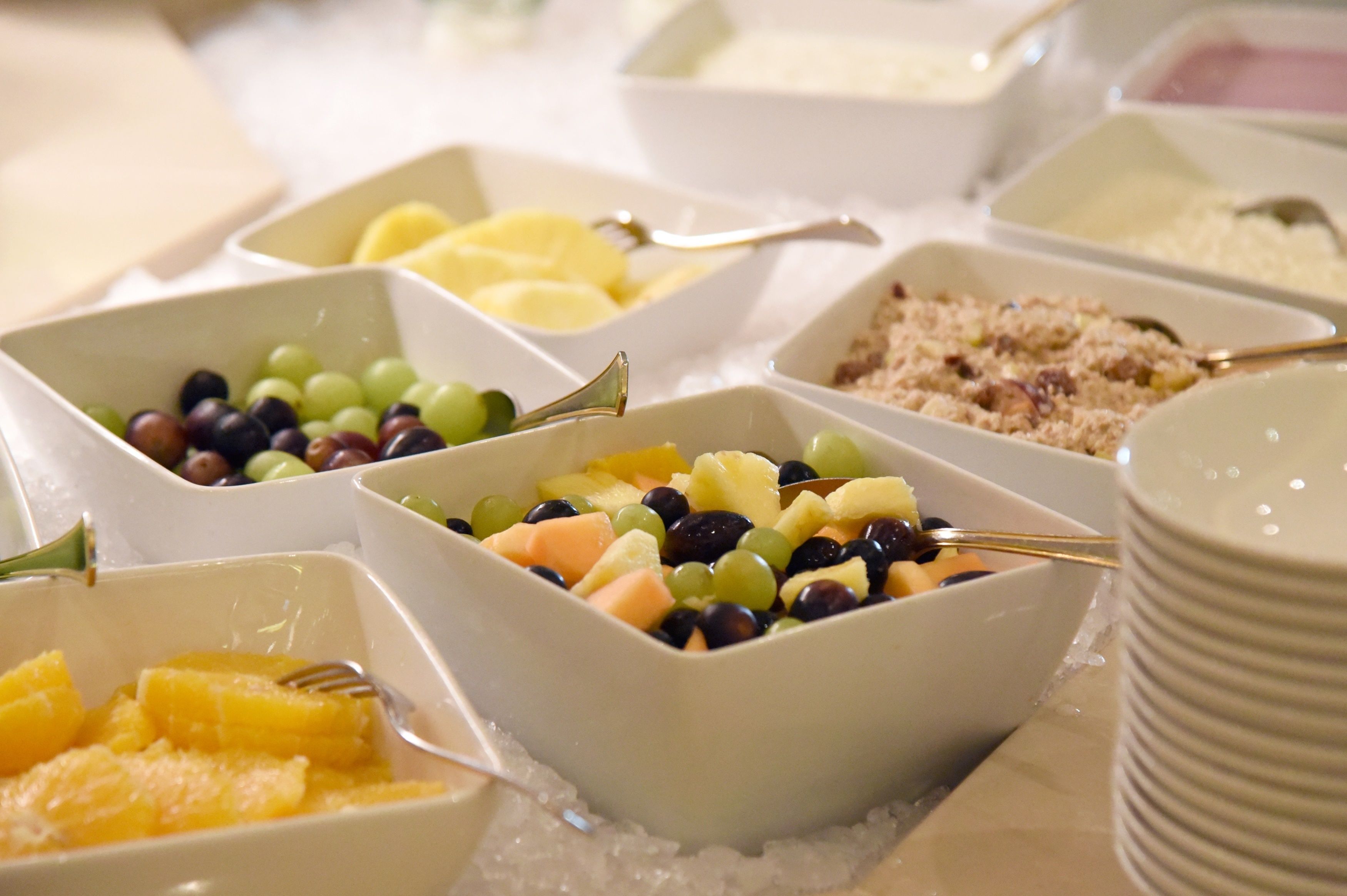 A buffet with various food items including fruits and grains.