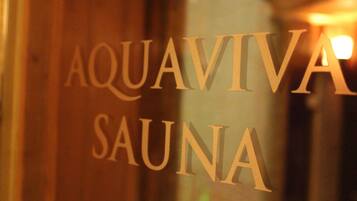 A sign with the words "AQUAVIVA SAUNA".