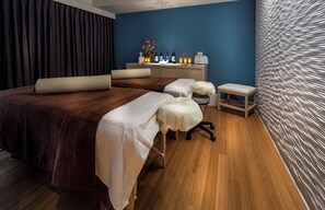 A hotel room with two beds, a small seating area, a vanity with toiletries, and a decorative wall. - The Godfrey Hotel Chicago (Chicago)