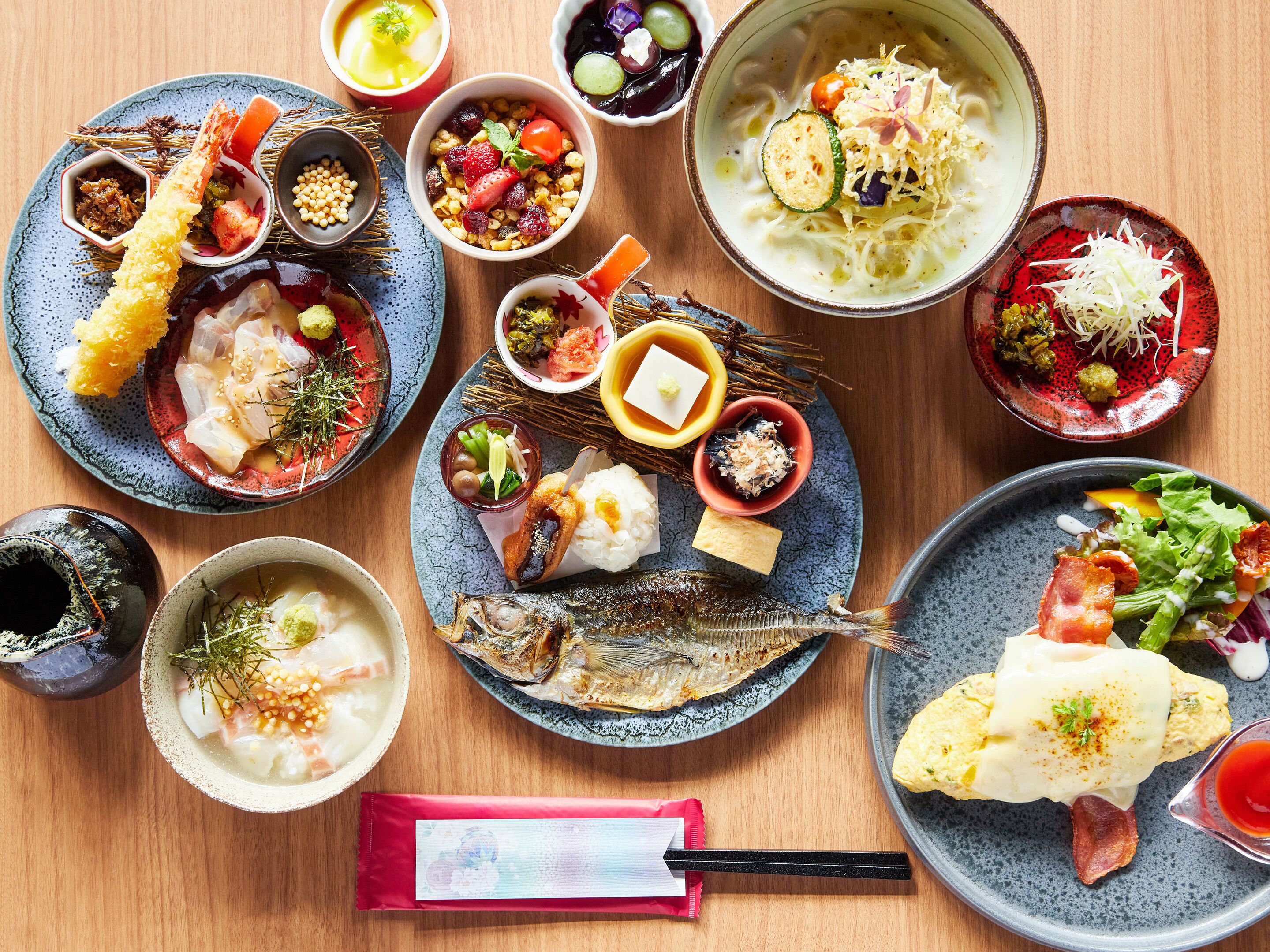 A variety of Japanese dishes arranged on a wooden table.