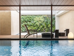 A modern indoor pool area with a clear view of a lush garden through large windows. - Mitsui Garden Hotel Osaka Premier(Mitsui Garden Hotel Osaka Nakanoshima Premier on Feb 26, 2027) (Osaka)