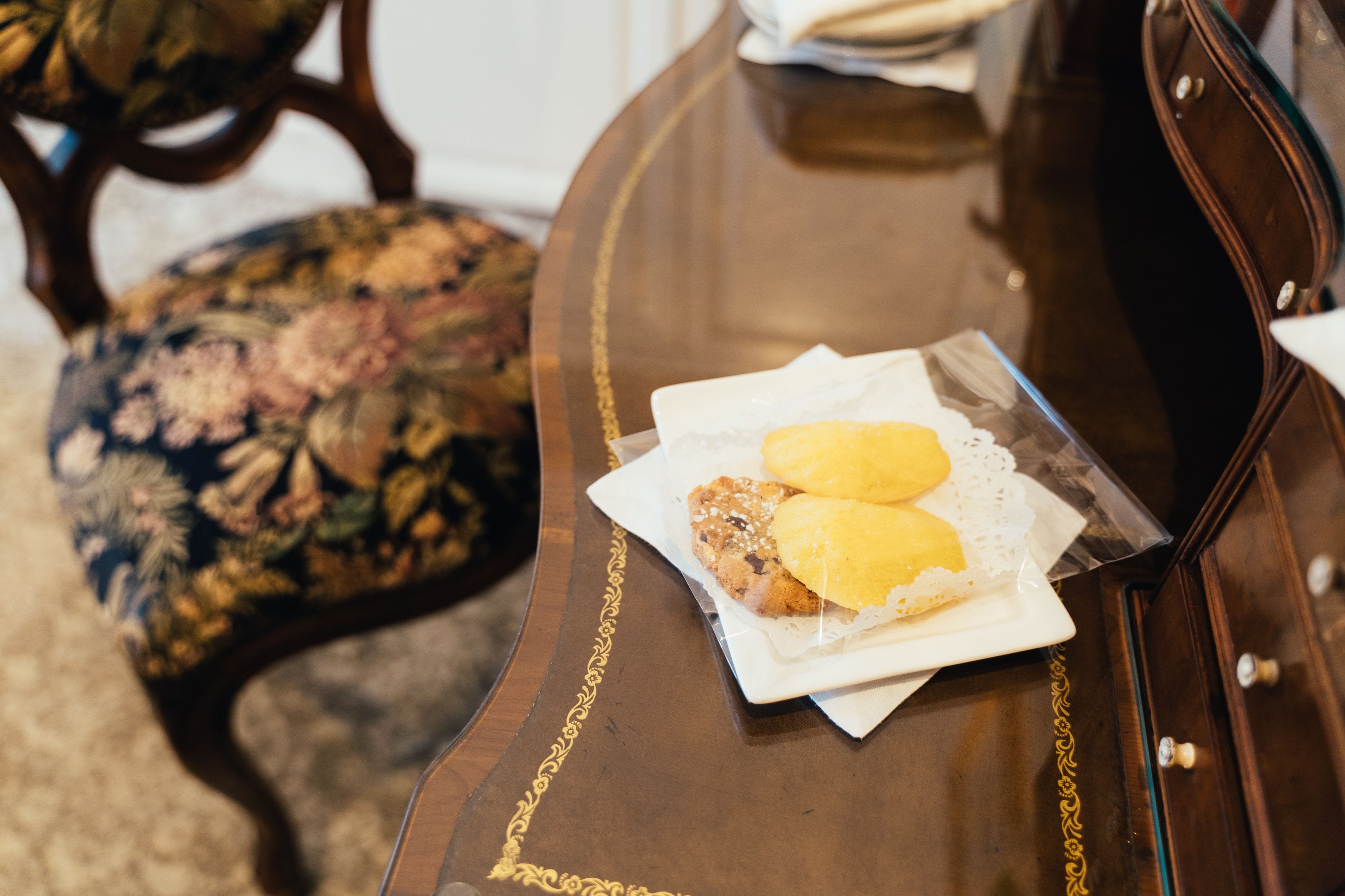 A wooden table with a tray containing two pastries and a napkin.