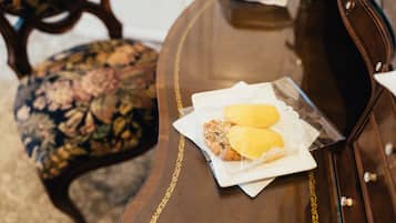 A wooden table with a tray containing two pastries and a napkin.
