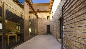 A narrow alleyway with stone walls and a wooden door.