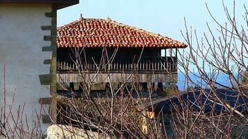 A building with a tiled roof and a balcony.