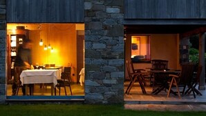A stone building with an open dining area and a covered outdoor seating space. - Rusticae Hotel Torre de Villademoros (Valdes)