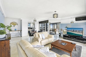 Deluxe Two Bedroom Ocean View Apartment | Living area | 55-inch flat-screen TV with cable channels, TV, DVD player - Surfers Century Oceanside Apartments (Surfers Paradise)