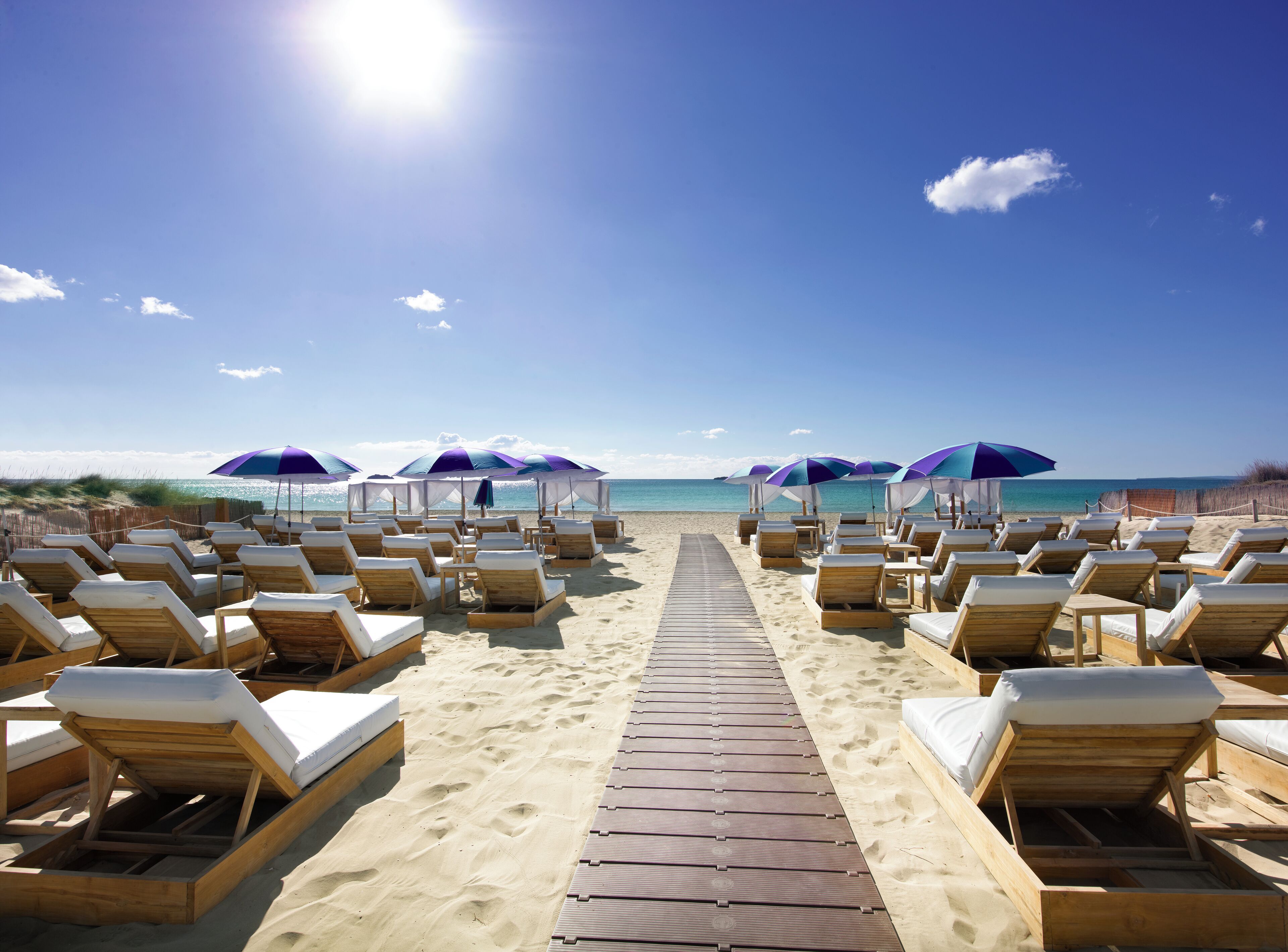 On the beach, sun-loungers, beach umbrellas, beach bar