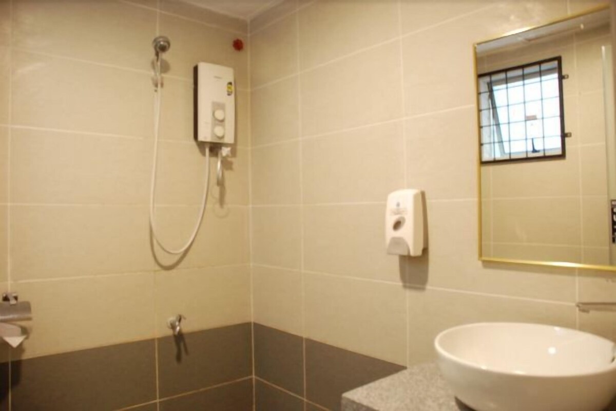 A bathroom with a shower, a sink, and a mirror.