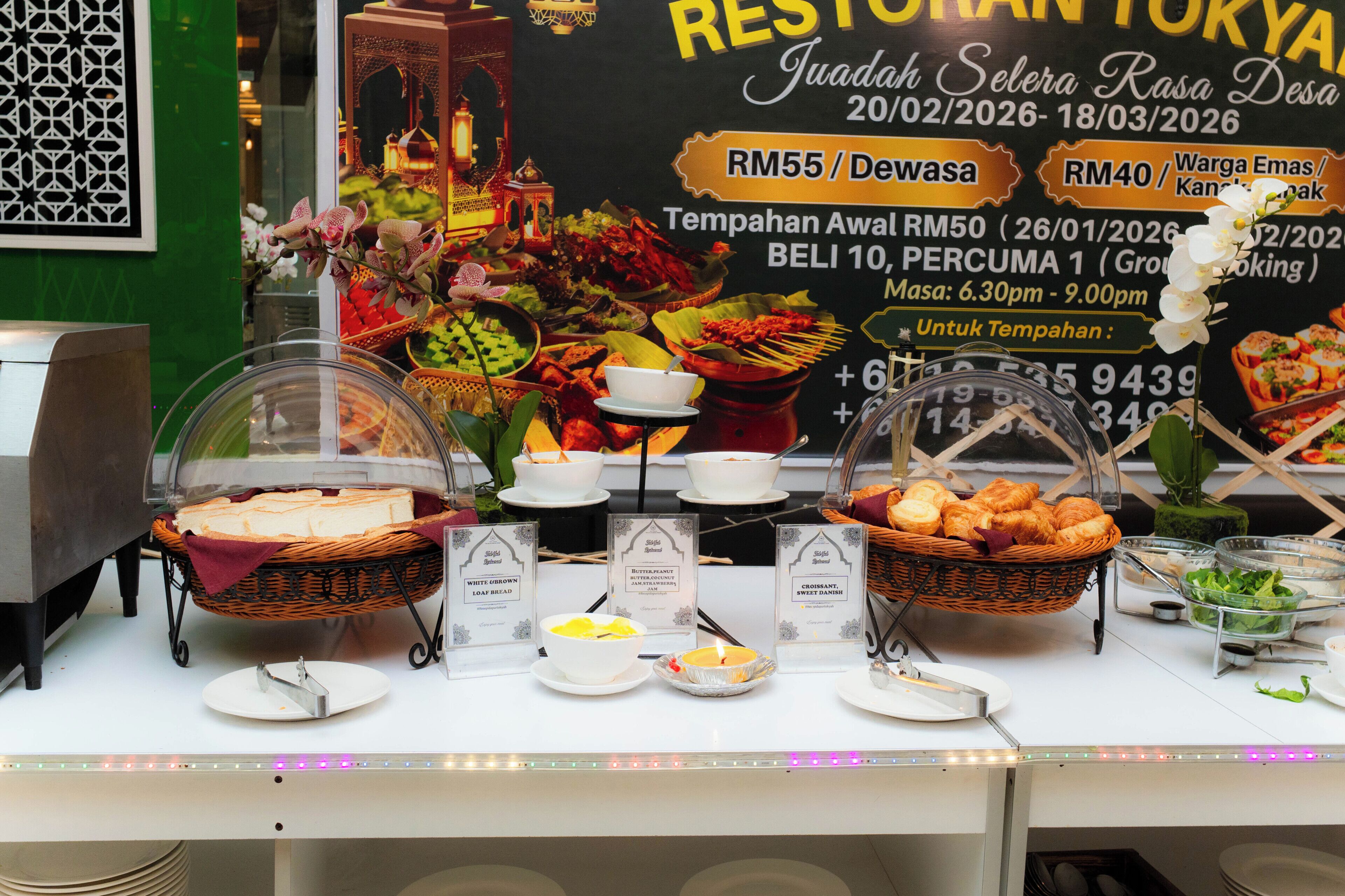 A buffet setup with various food items and a signboard in the background.