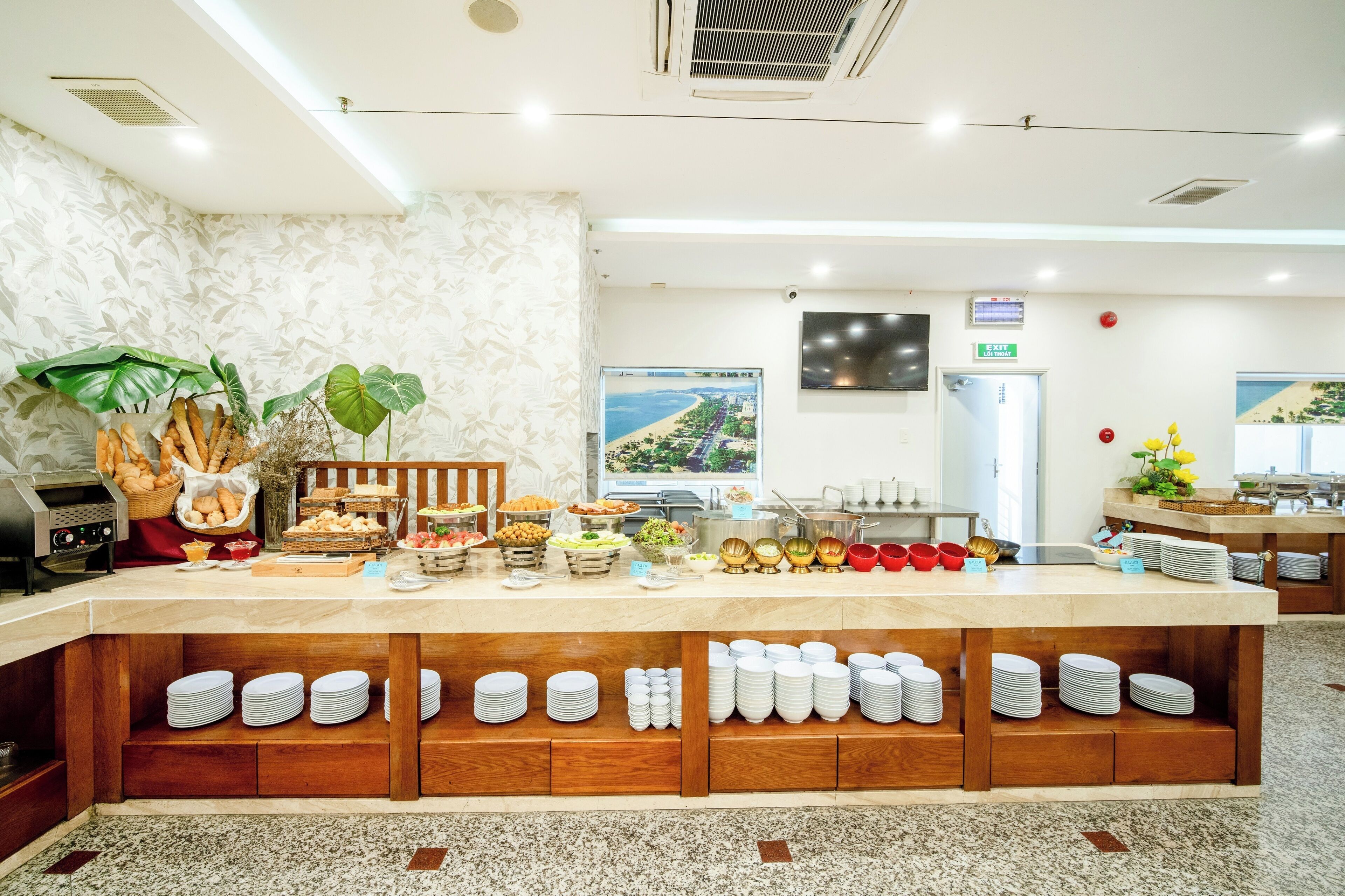 A buffet setup with various food items and plates arranged on wooden shelves.