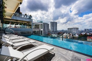 Relax by the rooftop pool with a stunning city view.