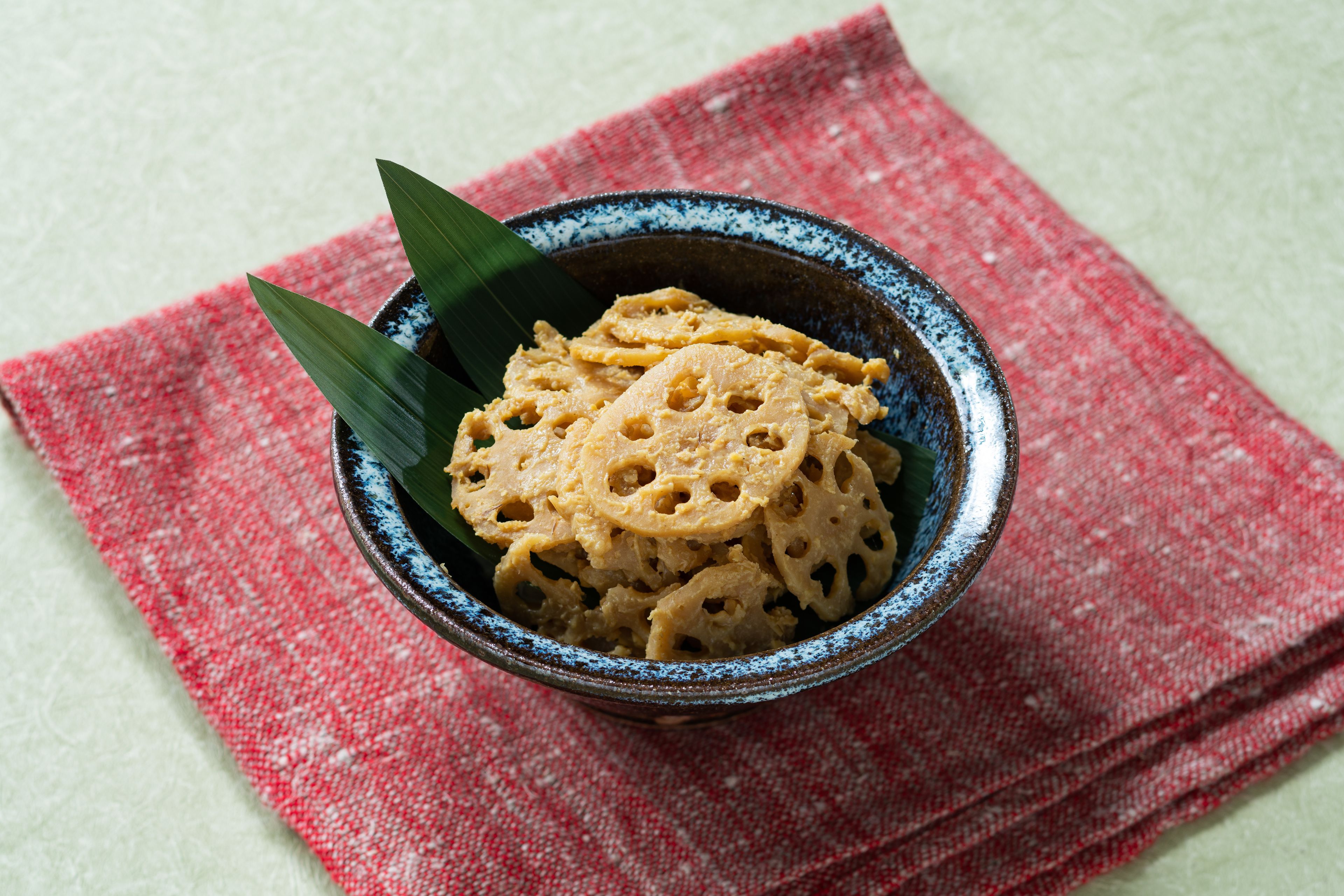 A bowl of food on a red cloth.
