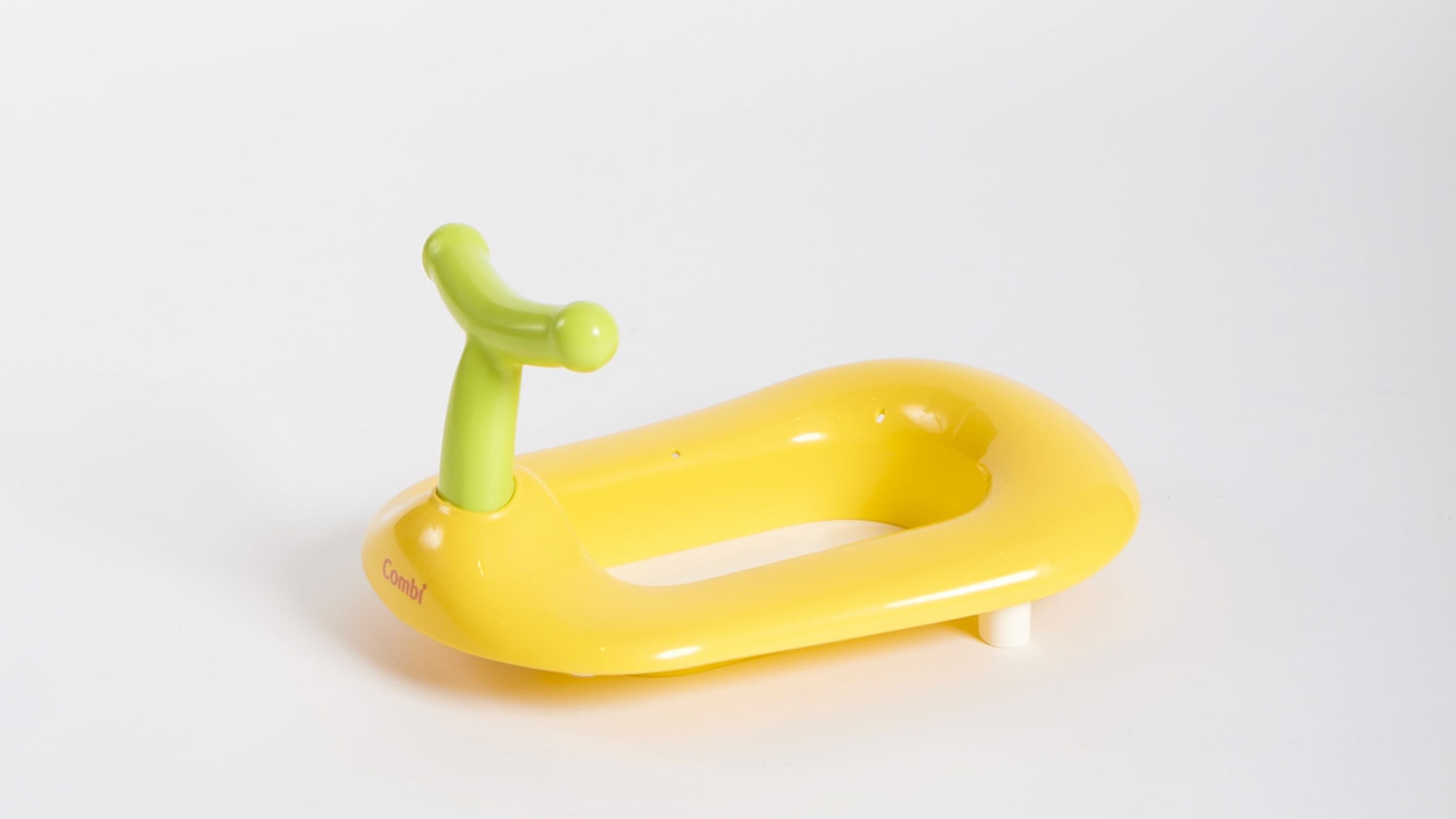A yellow inflatable pool with a green handle.
