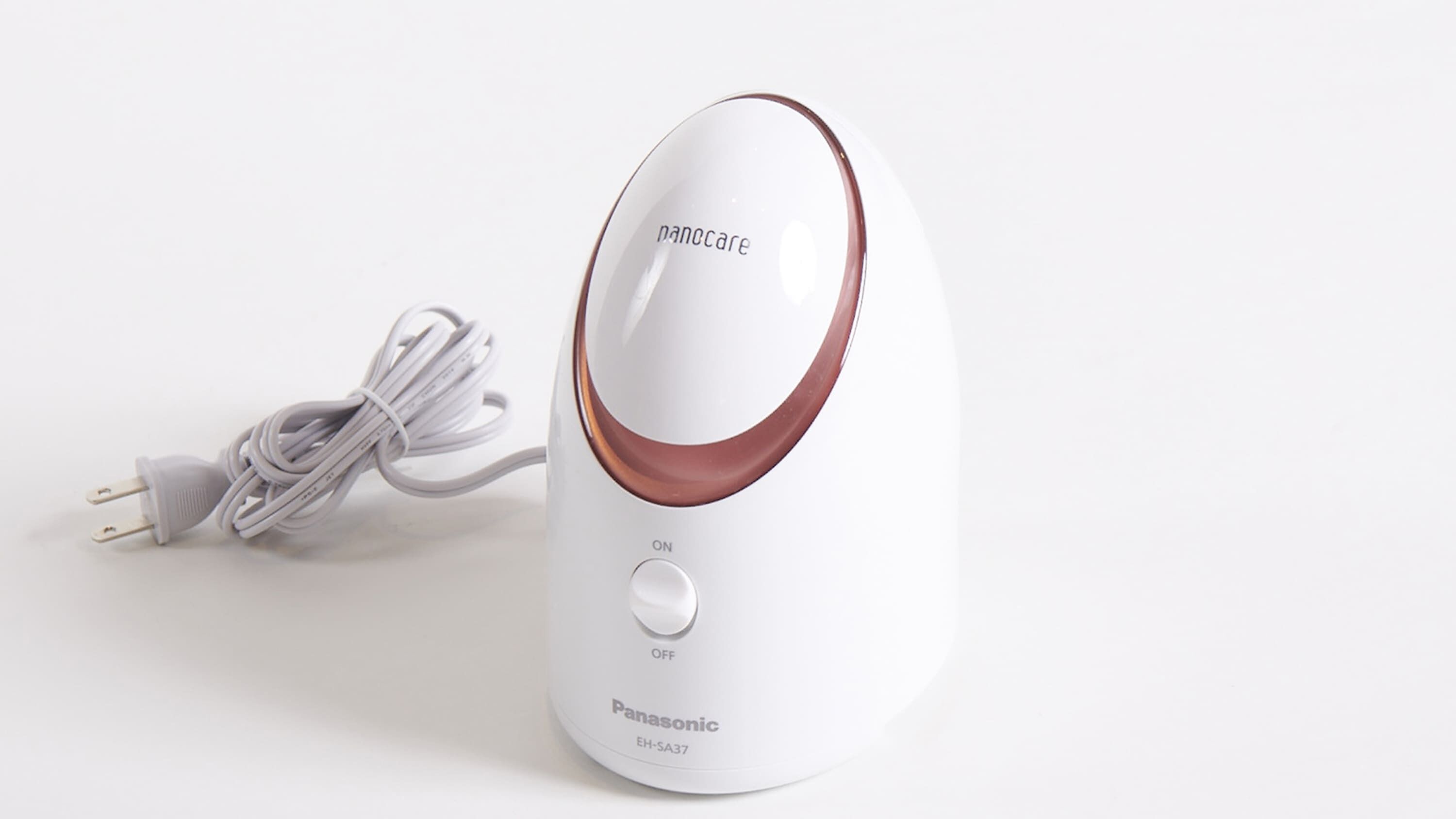 Dispositivo Panasonic EH-SA37 con cuerpo blanco y detalles en marrón, que incluye un interruptor de encendido/apagado y un cable de alimentación.