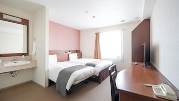 A hotel room with a bed, bedside table, TV, and a phone.